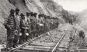 convict labor  - a work gang - black prisoners in prison stripes working on railroad tracks -- click on the image for a larger view and more information 