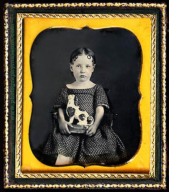 daguerreotype of a girl with a chalkware toy in the form of a Staffordshire Cavalier King Charles Spaniel