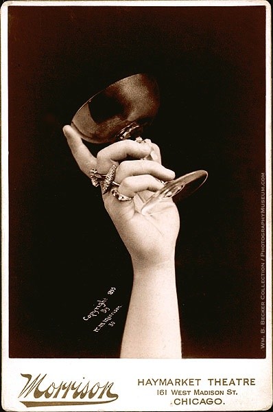 William Morrison, “Raising a Toast,” 1895 — a hand holding a goblet aloft against a plain dark ground