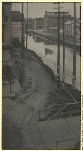 Clarence H. White, “Telegraph Poles,” 1898 — poles and low buildings along a canal in Newark, Ohio